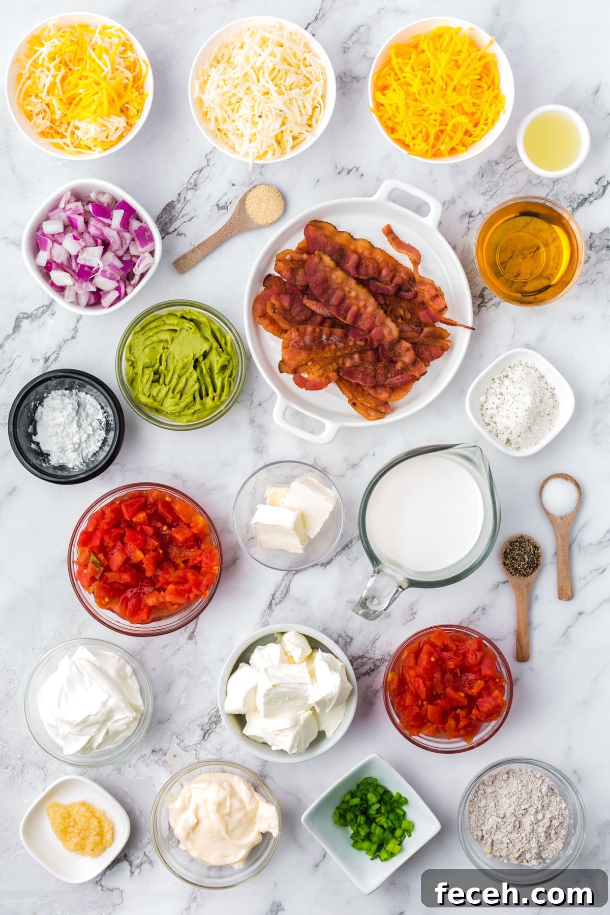 The ingredients needed to make a chip and dip board, including cream cheese, bacon, sour cream, shredded cheese, etc.