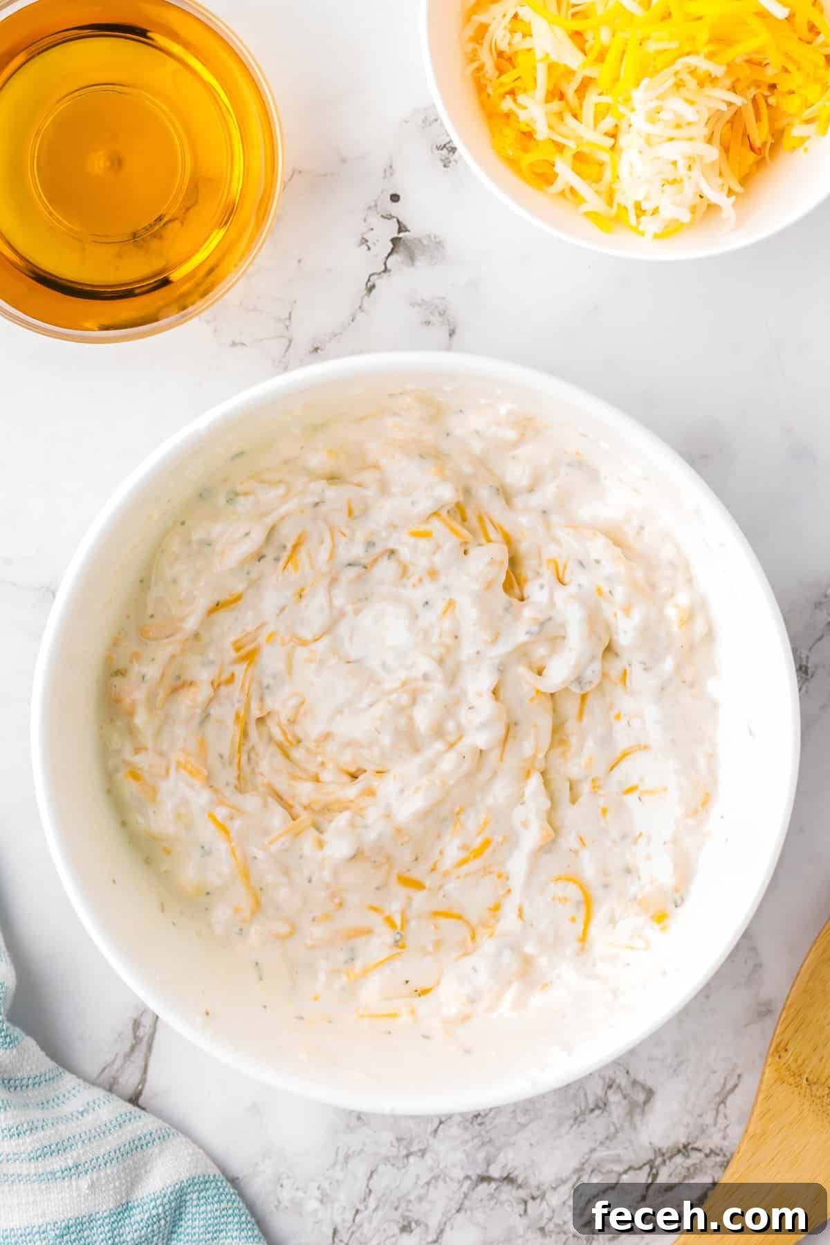 A bowl of cream cheese dip in a white bowl,