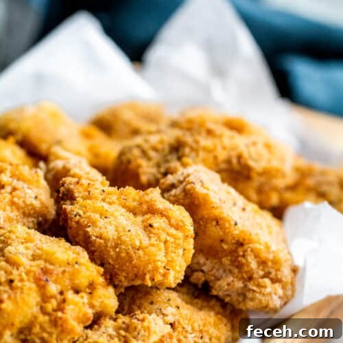 Popcorn chicken in wooden bowl.