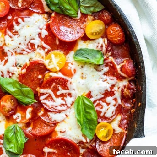 Overhead shot of chicken in a large black skillet.