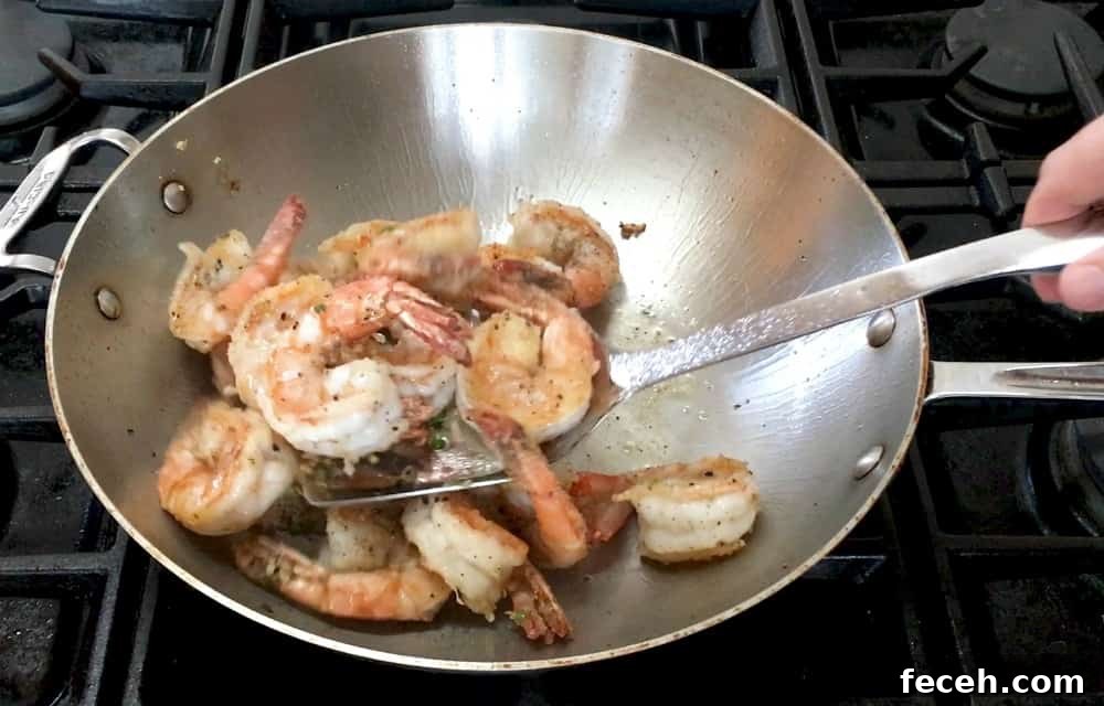 Crispy Salt and Pepper Shrimp Recipe with Garlic and Chili 11 Stirring to Coat Shrimp