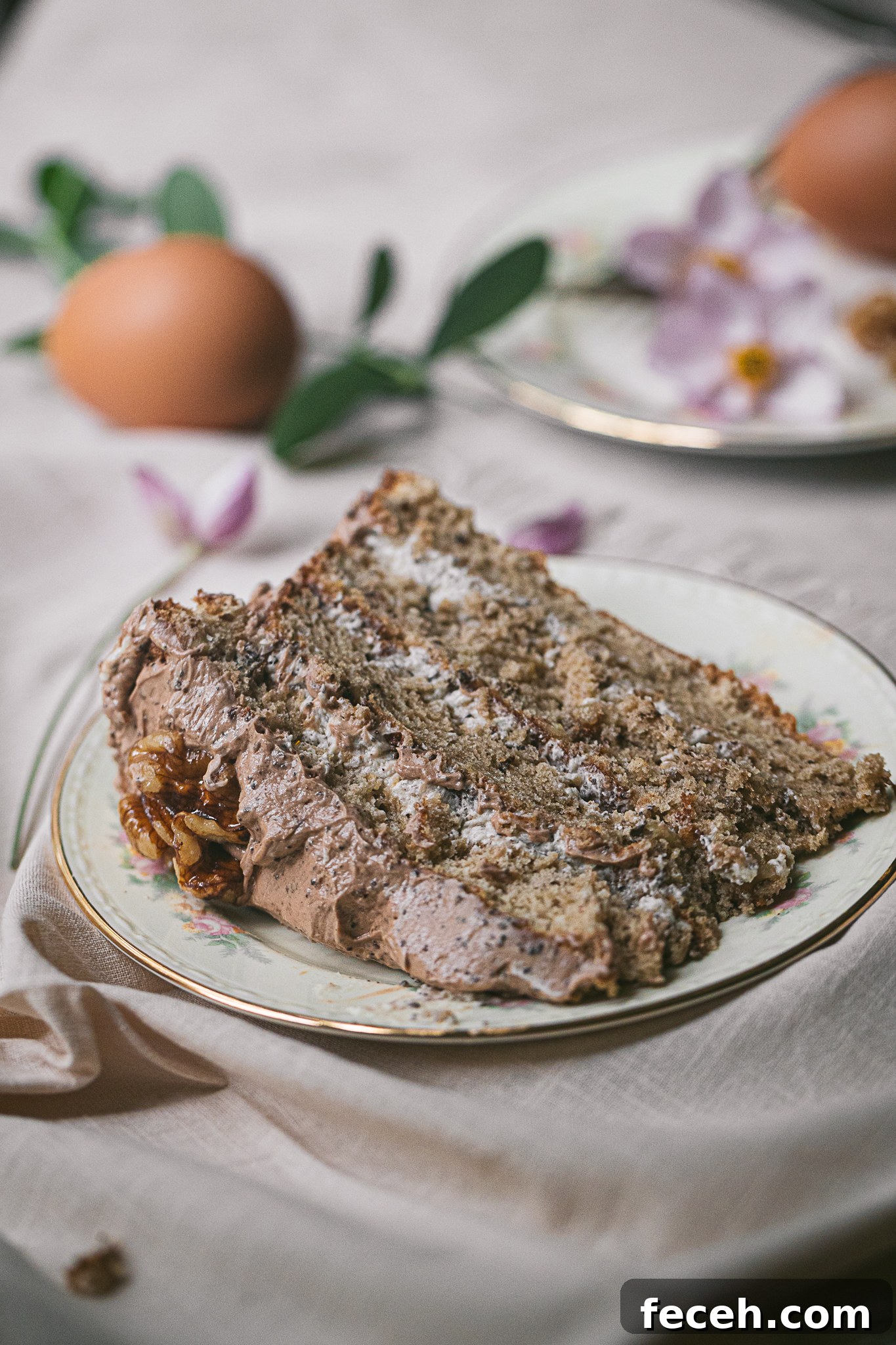 A slice of Walnut Torte that shows three layers of cake and icing.