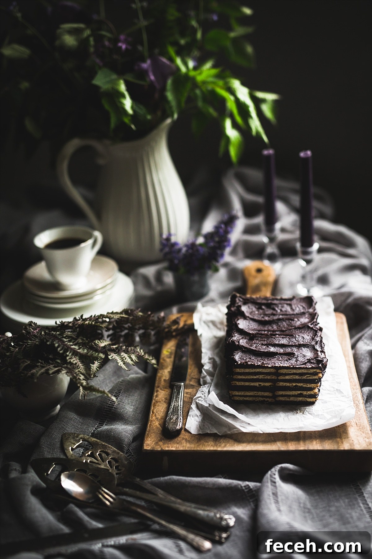 Kalter Hund Recipe: Authentic German No-Bake Chocolate Biscuit Cake 9 Backlit image of no bake layered Kalter Hund that has a slice taken out of it so you can see the layers of the cake.