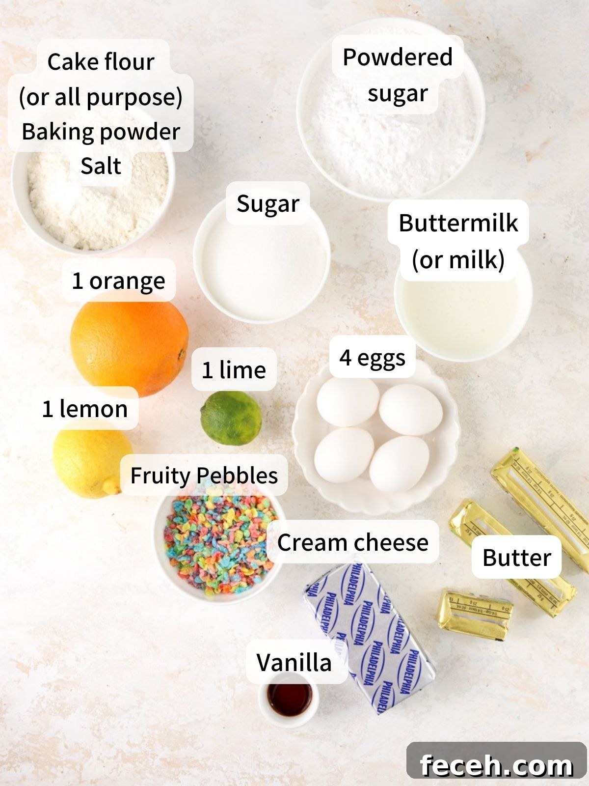 Labeled ingredients needed to make fruity pebbles cake laid out on a table.
