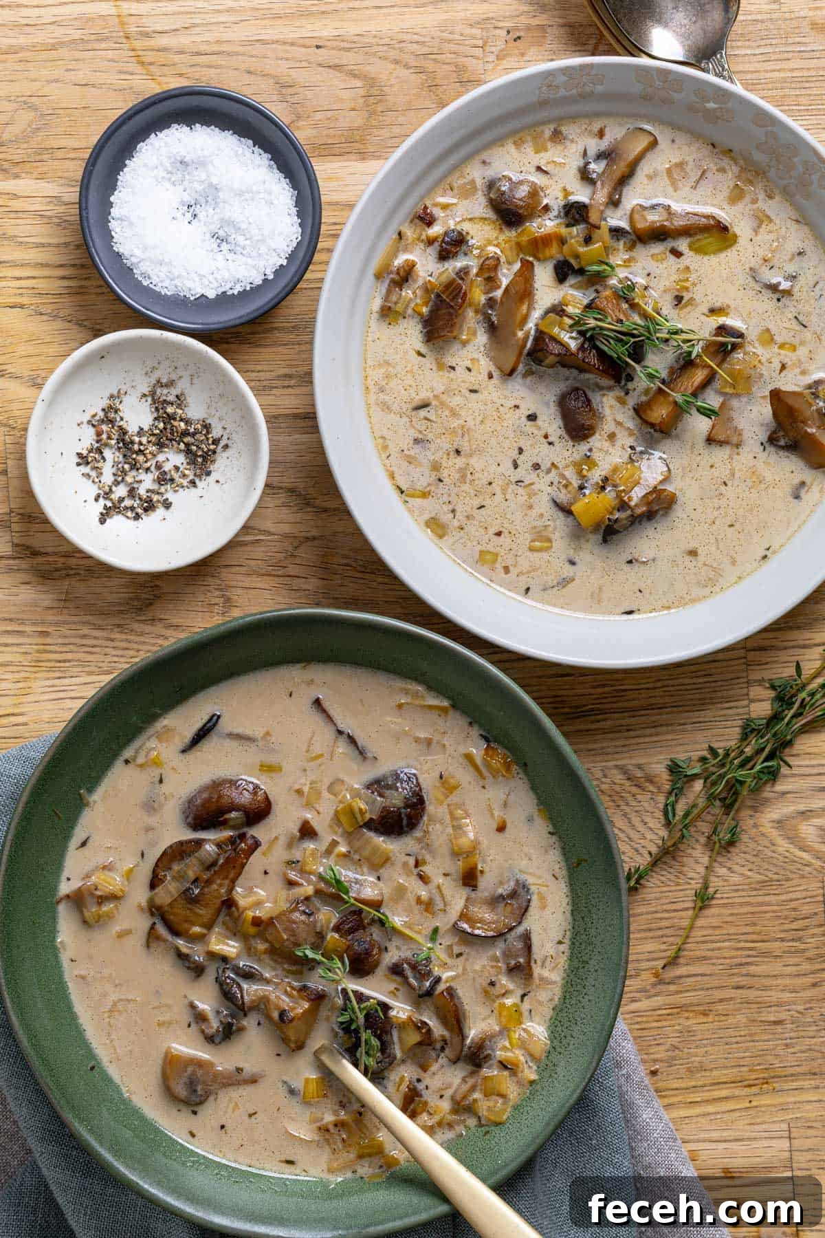 A close up of two servings of mushroom and leek soup.