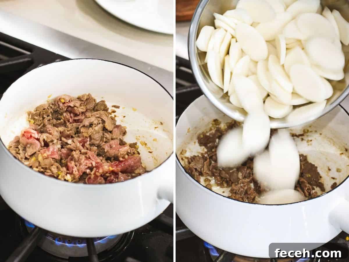 Korean rice cakes added to a pot with sautéed beef.