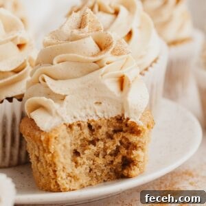 A close up of a coffee cupcake with a bite taken out of it.