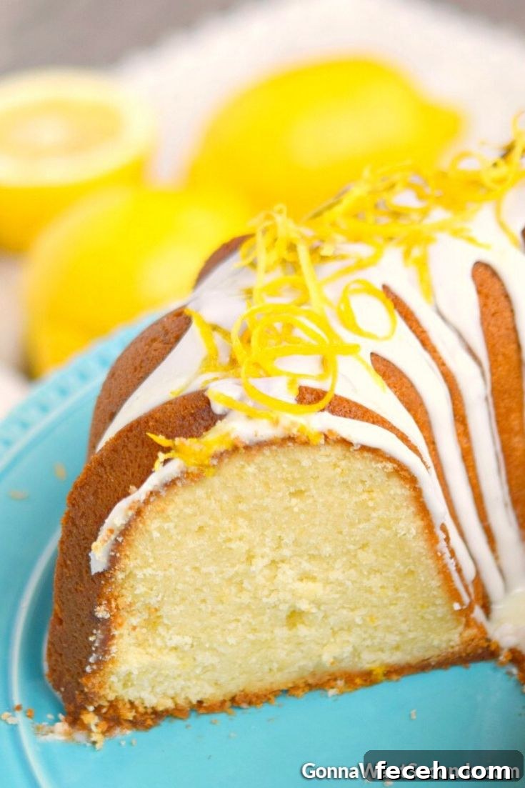 Lemon cream cheese pound cake is a moist decadent springtime treat covered in a sweet lemon glaze that offers a little sunshine in every bite. #poundcake #lemoncake Sliced lemon pound cake with cream cheese