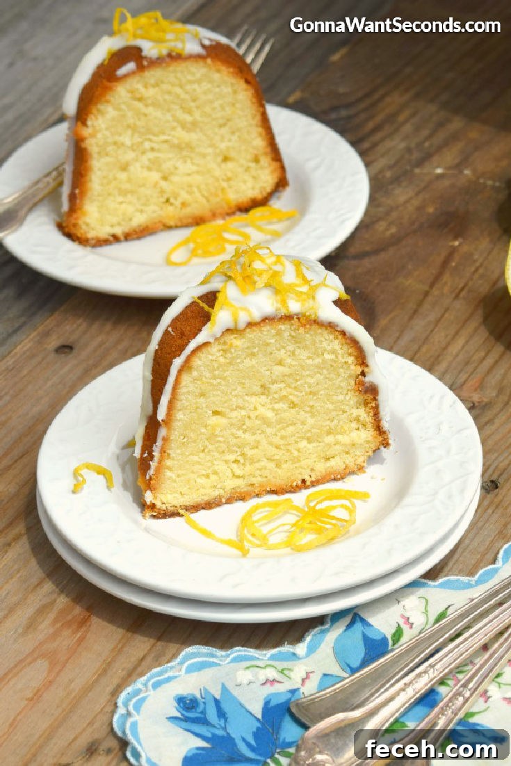 Lemon cream cheese pound cake is a moist decadent springtime treat covered in a sweet lemon glaze that offers a little sunshine in every bite. #poundcake #lemoncake a slice of lemon pound cake with glaze