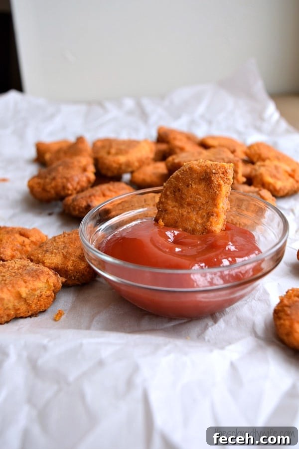 Gluten-Free Baked Chicken Nuggets for a Lighter Crunch 4 Chicken Nuggets dipped into ketchup