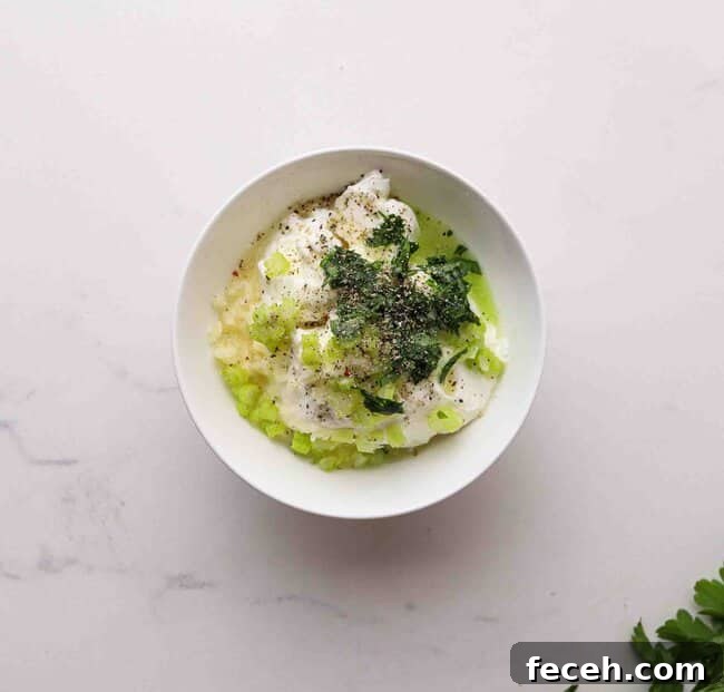 Quick Greek Yogurt Ranch Dip Ready in 5 Minutes 4 Yogurt, mayo, and fresh herbs in a bowl.