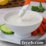 Quick Greek Yogurt Ranch Dip Ready in 5 Minutes 6 Carrot dipping into a bowl of ranch dressing.