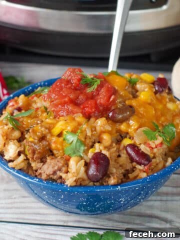 a bowl of cowboy casserole in front of a crock pot