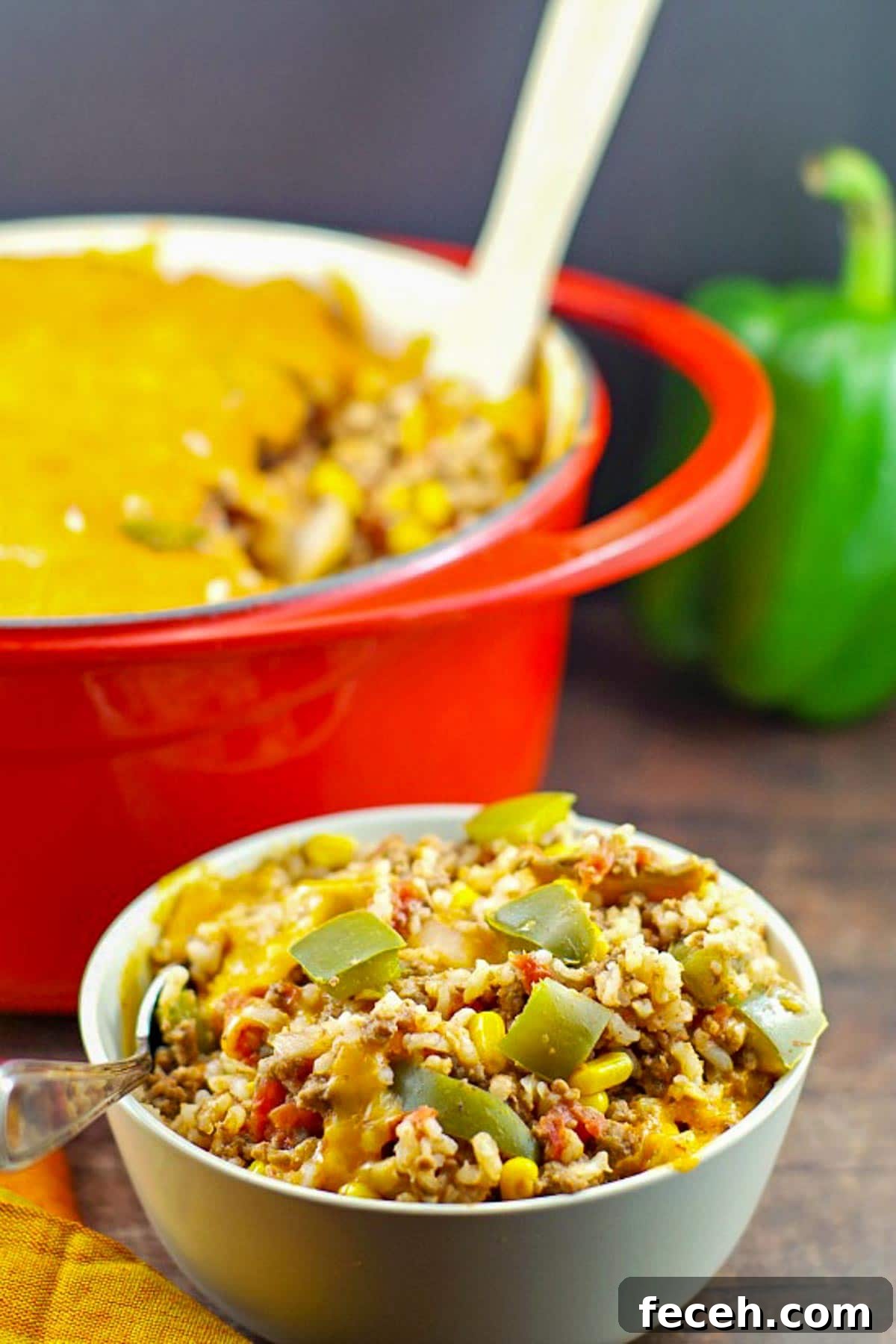 WW-Friendly Stuffed Green Pepper Casserole Recipe 6 bowl of ww stuffed green pepper casserole in front of a orange casserole dish in background