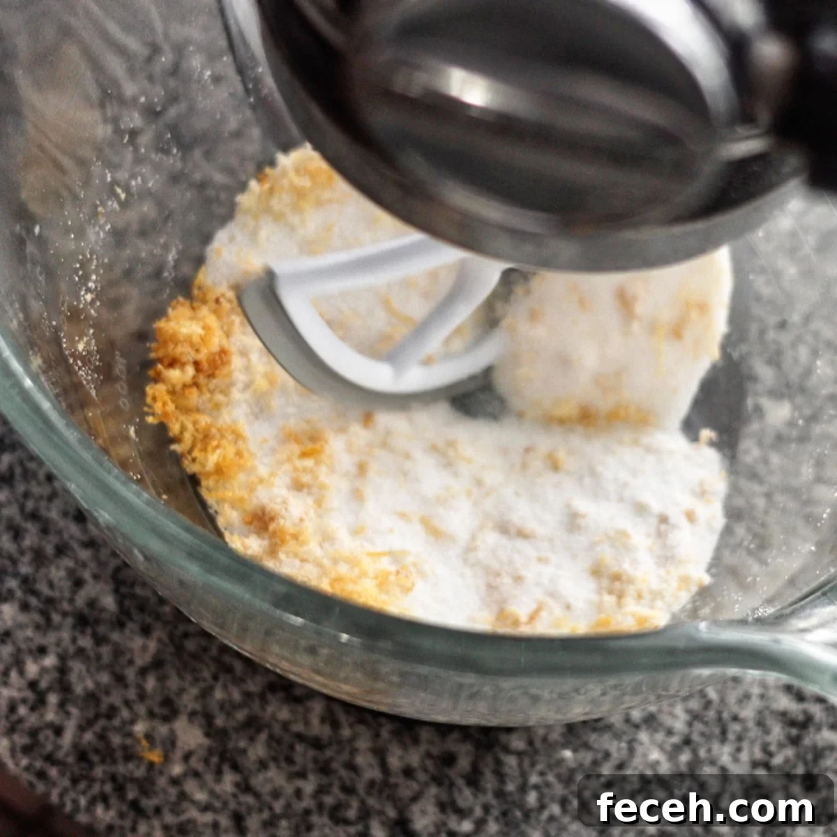 mixing lemon zest and sugar in bowl of stand mixer.