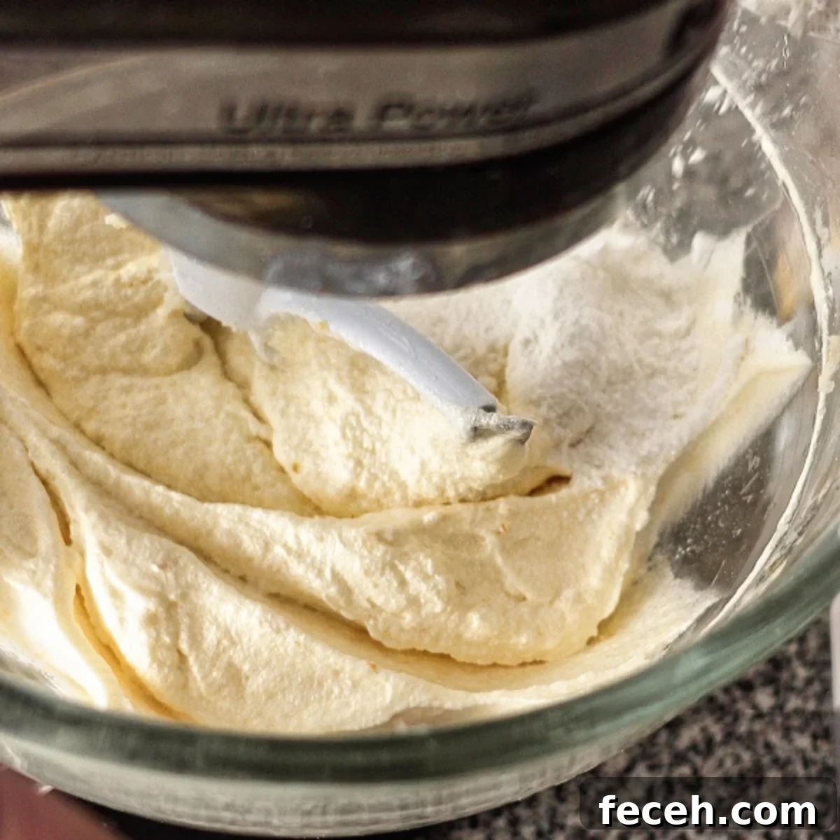 adding flour to batter in glass mixing bowl.