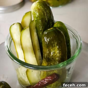 fermented pickles in a weck jar with a red hot pepper.