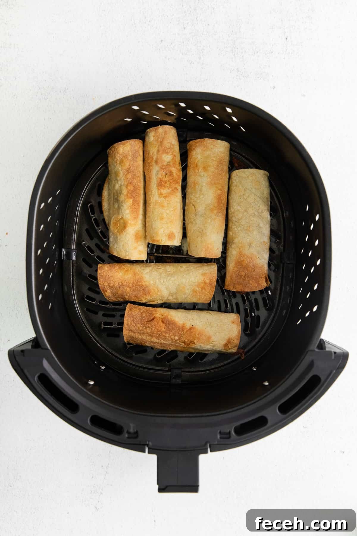 Taquitos in an air fryer basket