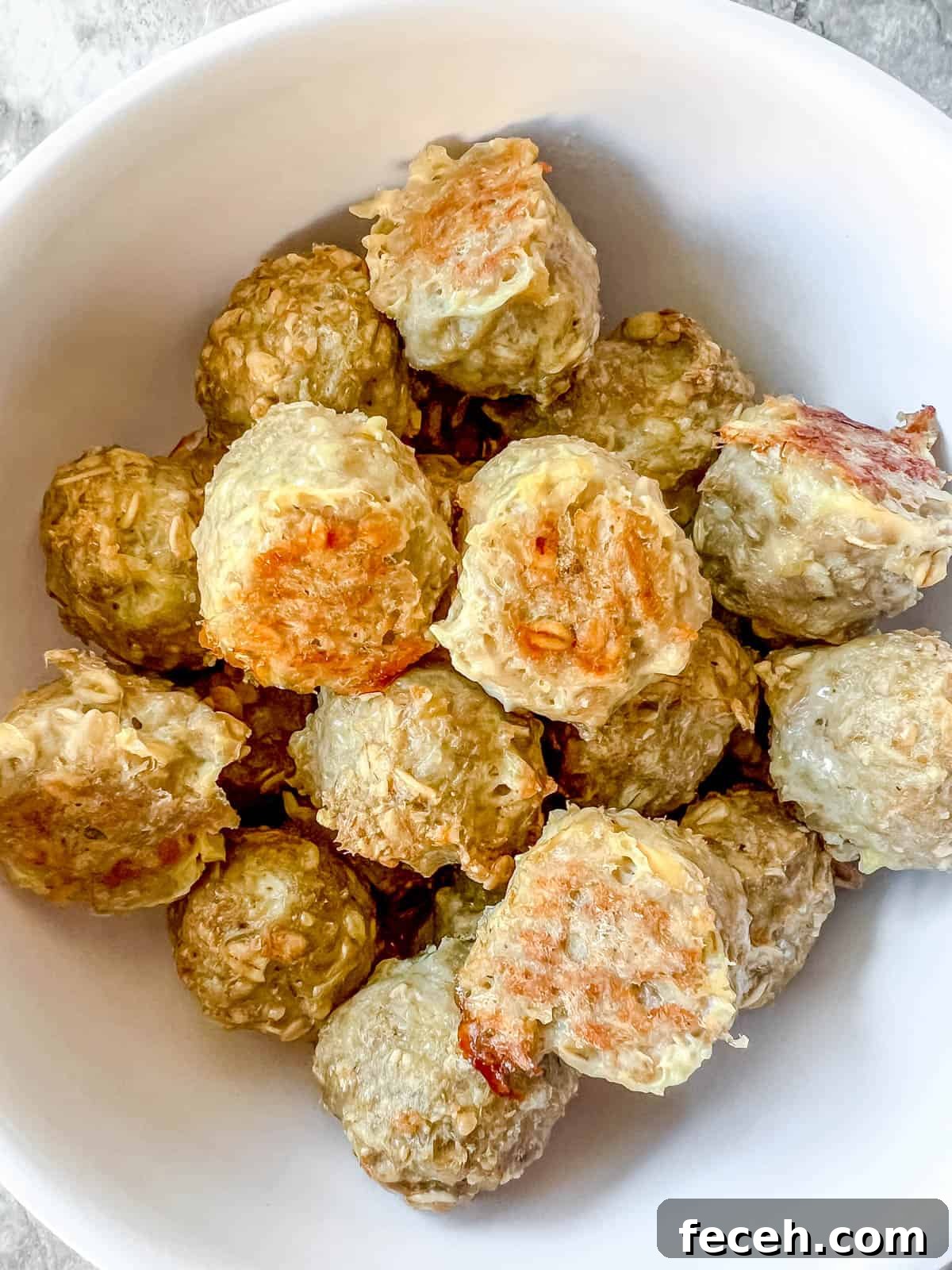 Gluten-Free Baked Turkey Meatballs Recipe 2 Gluten free baked turkey meatballs in a bowl.