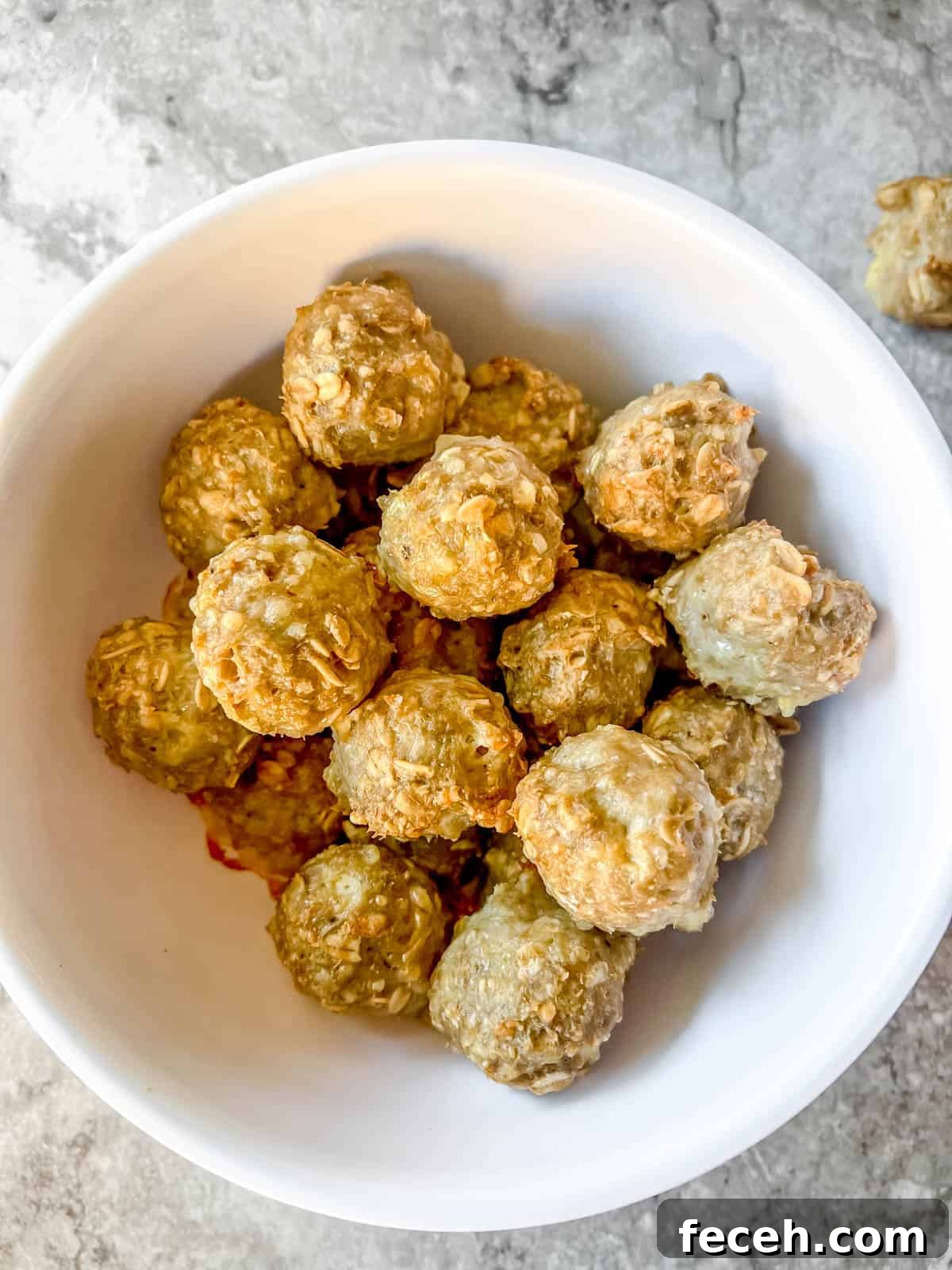 Gluten-Free Baked Turkey Meatballs Recipe 8 Gluten free turkey meatballs made with oats in a bowl.