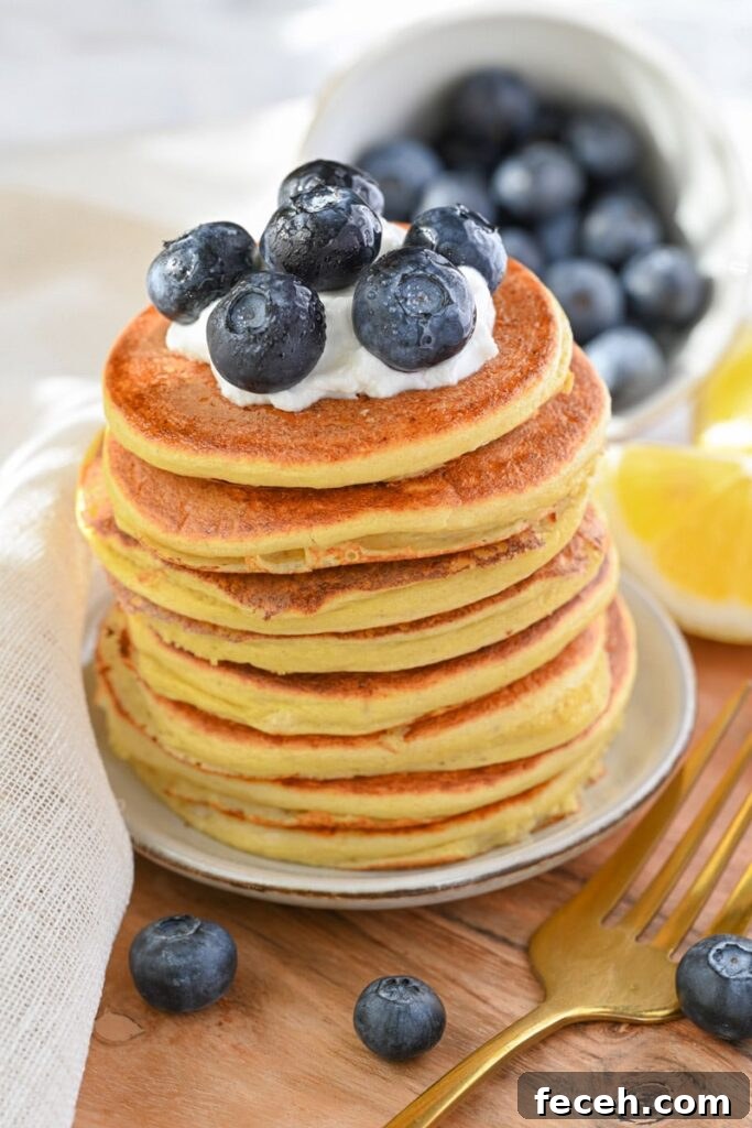 Low-Calorie Pancakes Recipe for Fluffy, Guilt-Free Breakfast 2 low calorie pancakes for weight loss, with blueberries and yogurt