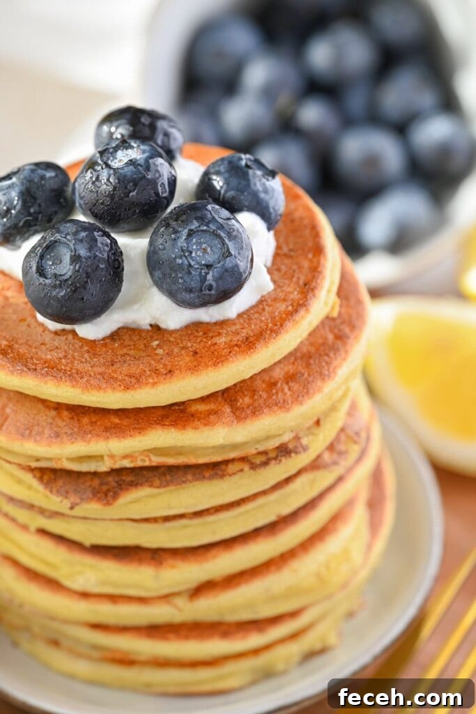 Low-Calorie Pancakes Recipe for Fluffy, Guilt-Free Breakfast 3 low calorie pancake with Greek yogurt and blueberries