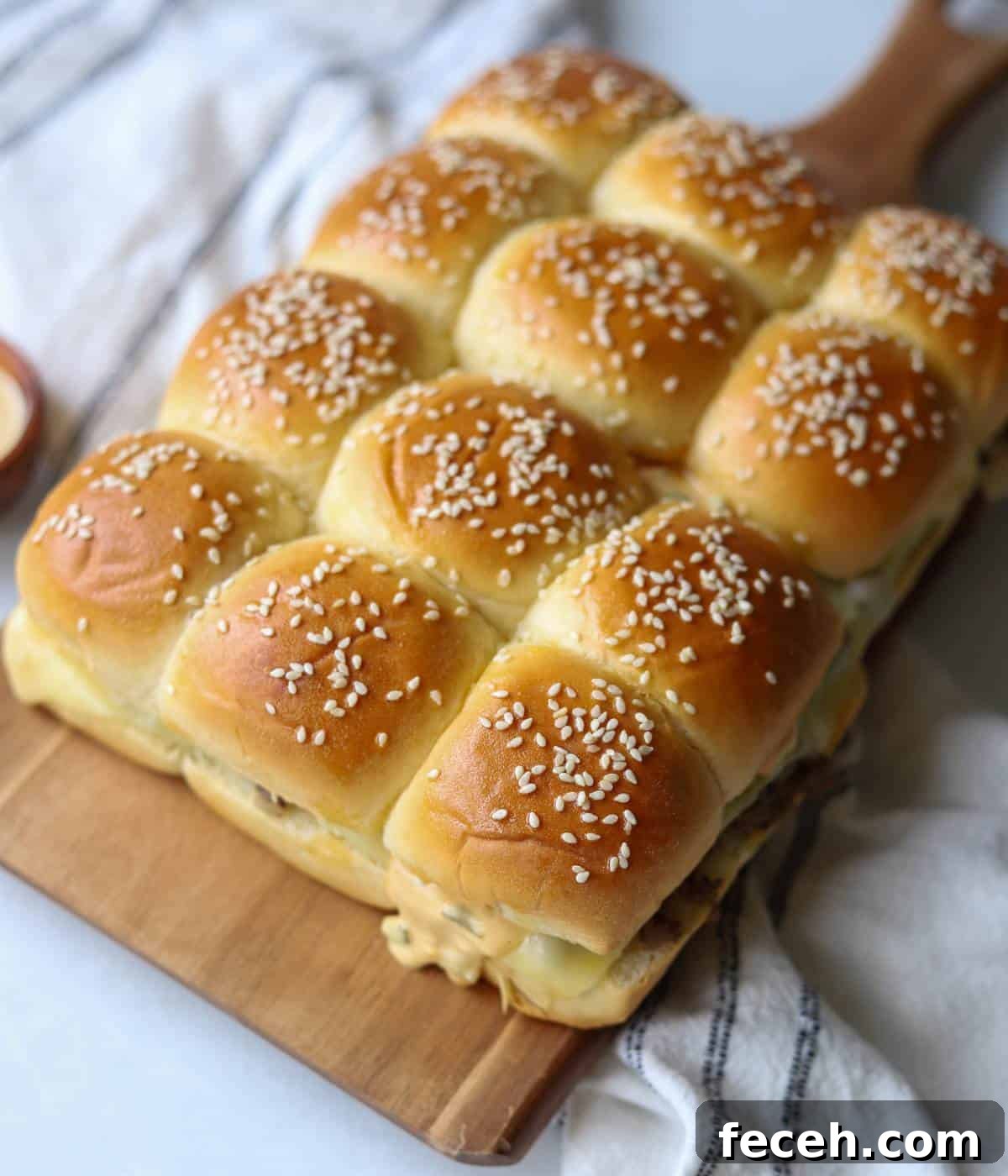 Hawaiian Roll Cheeseburger Sliders Recipe for Party Appetizers 10 Cheeseburger sliders with hawaiian rolls on wood board.