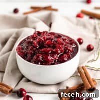 Cinnamon sticks with cranberry sauce in a bowl.