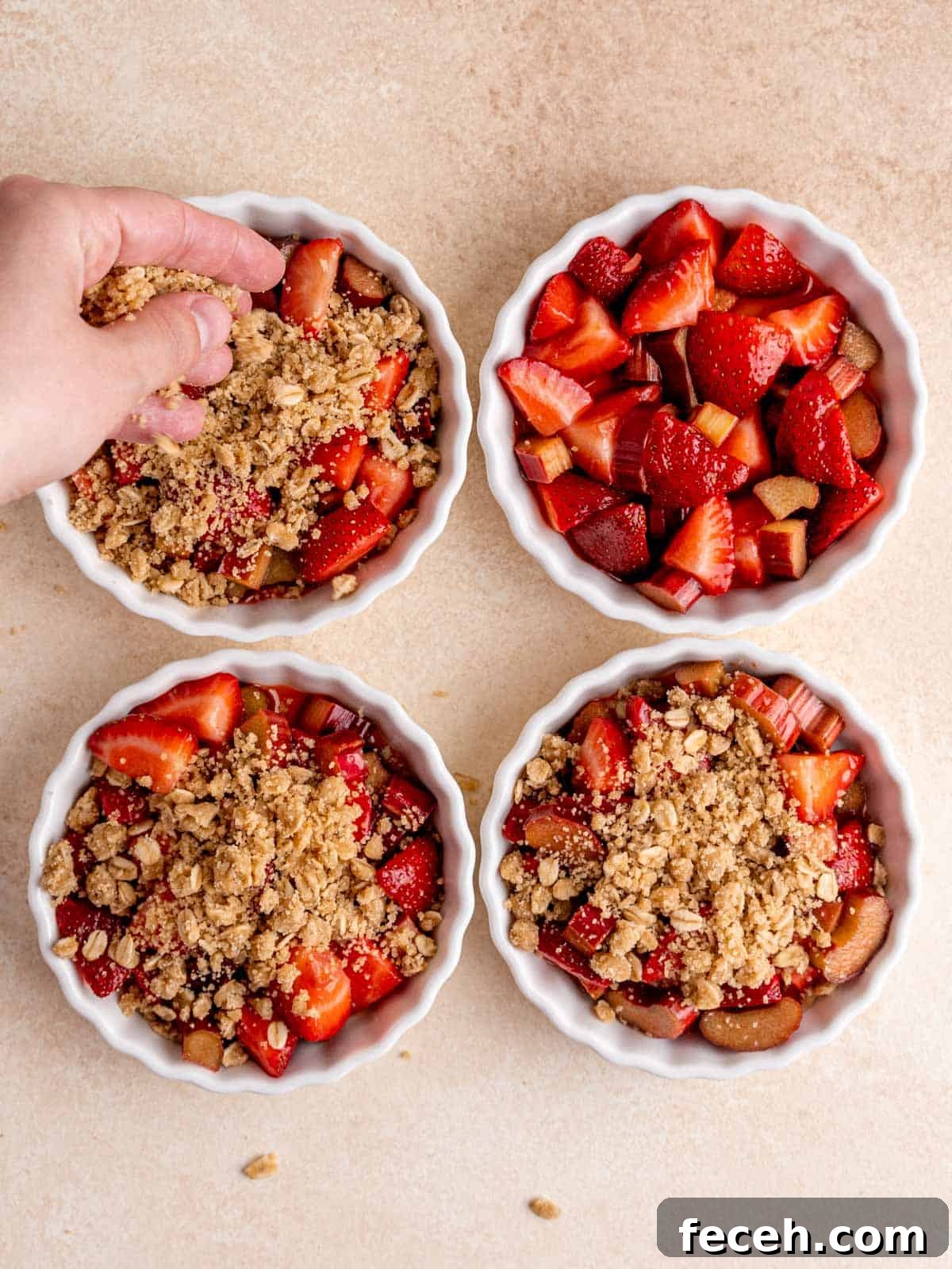 Sprinkling the crumbly mixture over the strawberry rhubarb filling in ramekins.