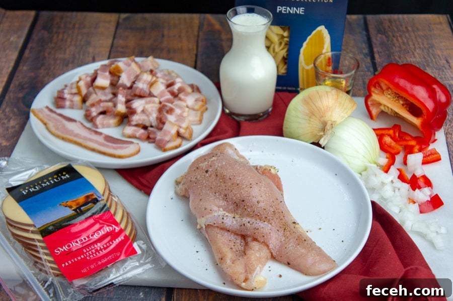 Creamy Chicken and Bacon Pasta Recipe for Weeknight Dinners 4 chicken breast on a plate, bacon, pasta, cheese and diced bell peppers on a table