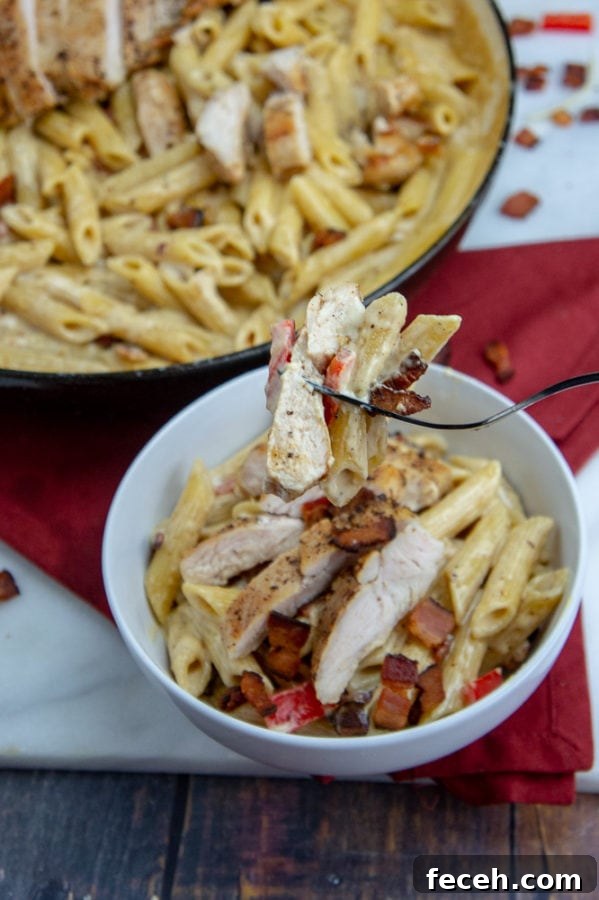 Creamy Chicken and Bacon Pasta Recipe for Weeknight Dinners 5 a fork holding up a bite of smoked gouda pasta
