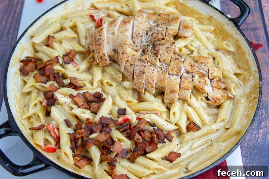 Creamy Chicken and Bacon Pasta Recipe for Weeknight Dinners 6 a wide pan of creamy chicken pasta with bacon and bell peppers