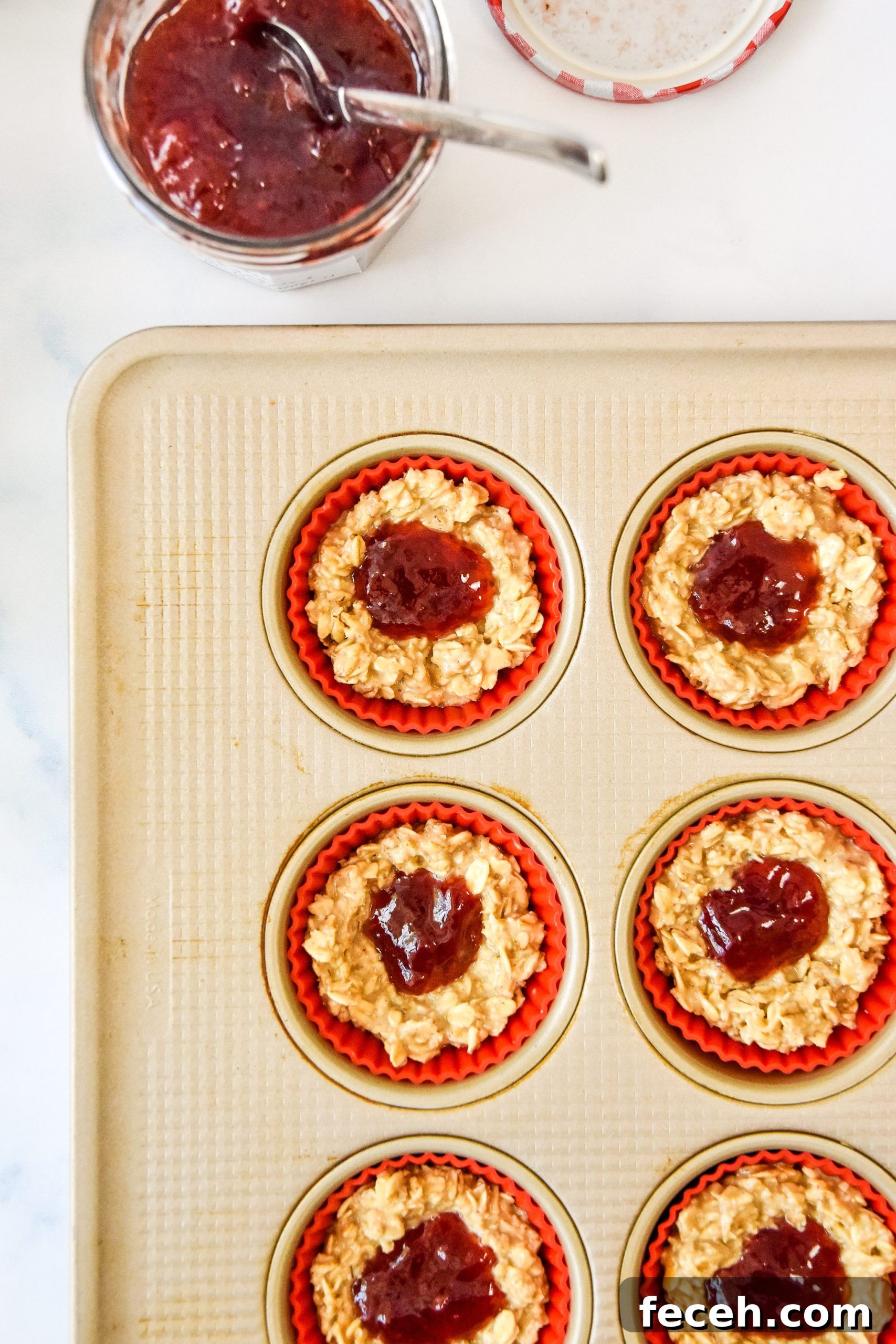 jelly in the center of each oatmeal cup in the muffin tin.