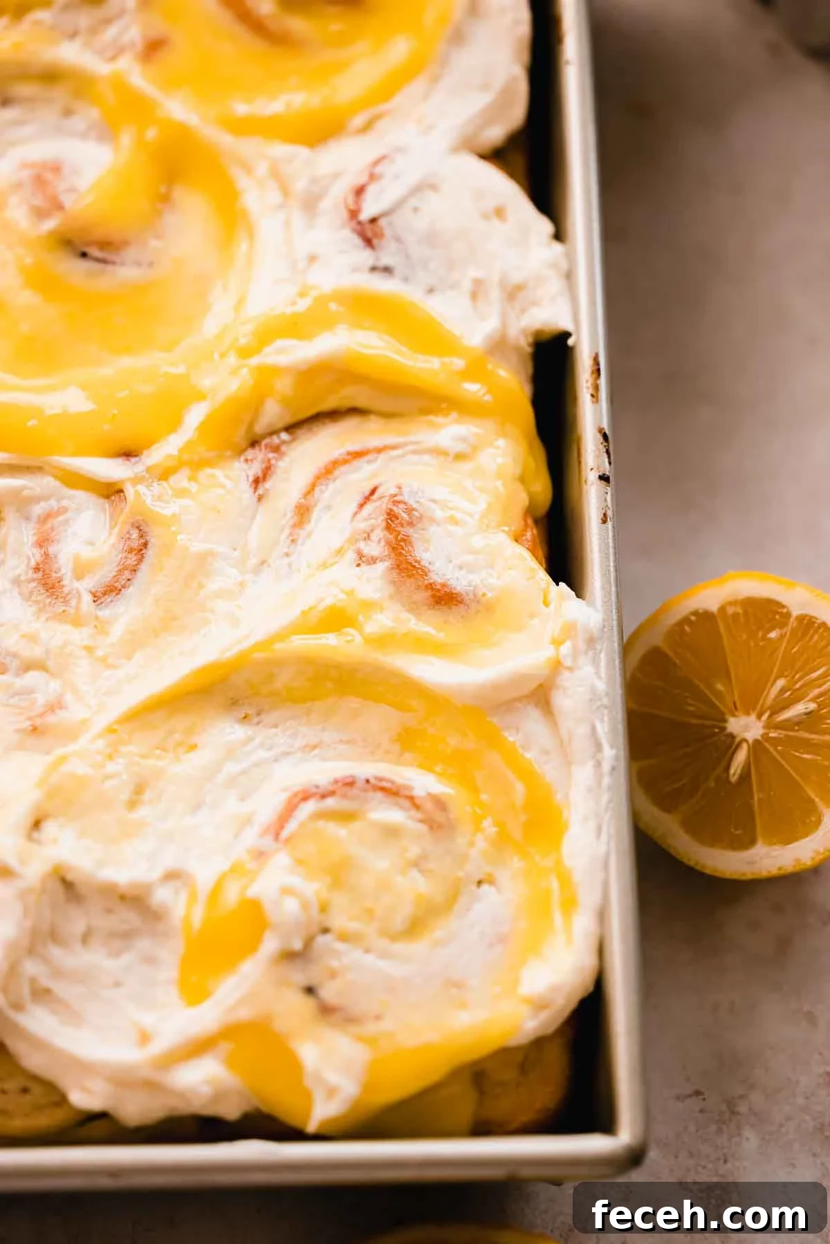 lemon sweet rolls topped with frosting and lemon curd