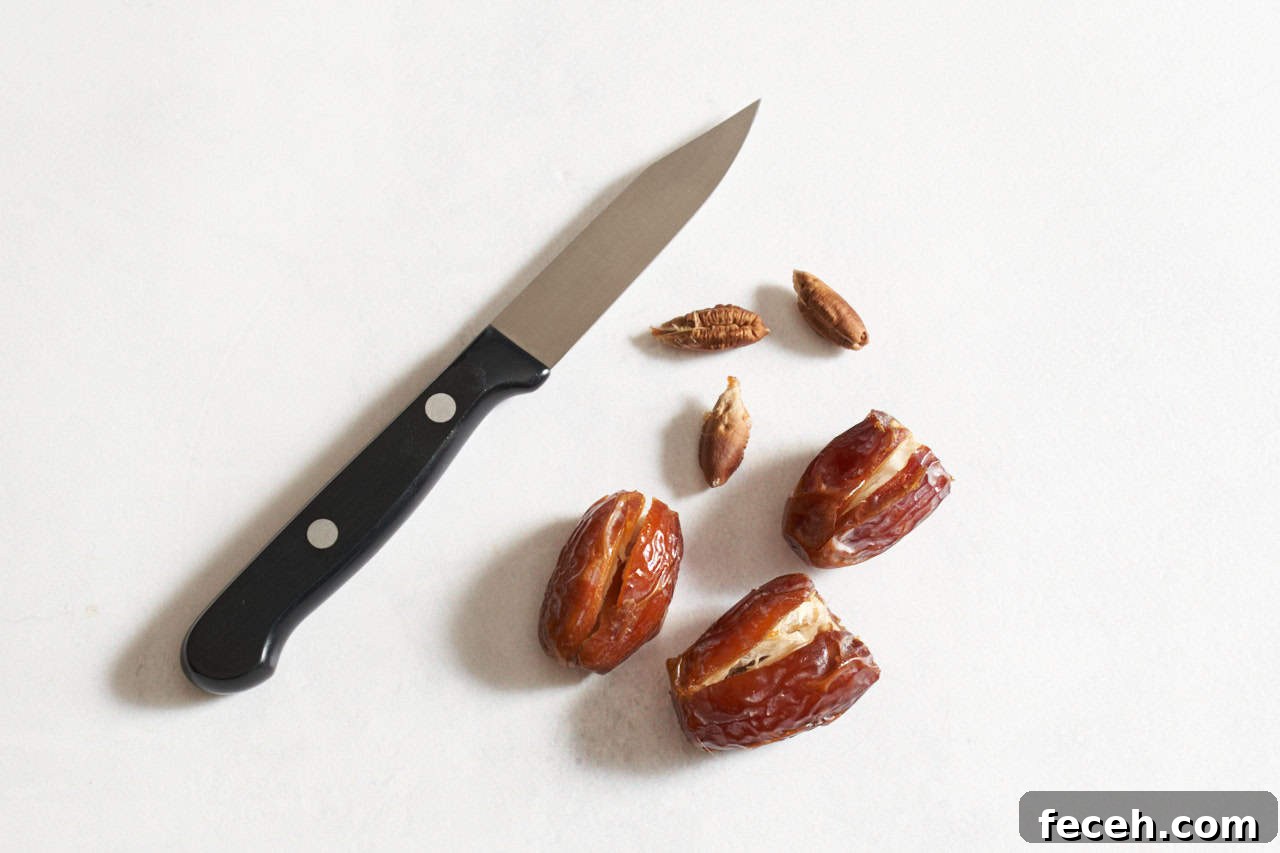 Prosciutto-Wrapped Dates with Goat Cheese and Honey Drizzle 4 A small paring knife next to dates that have been sliced open to remove the pits.
