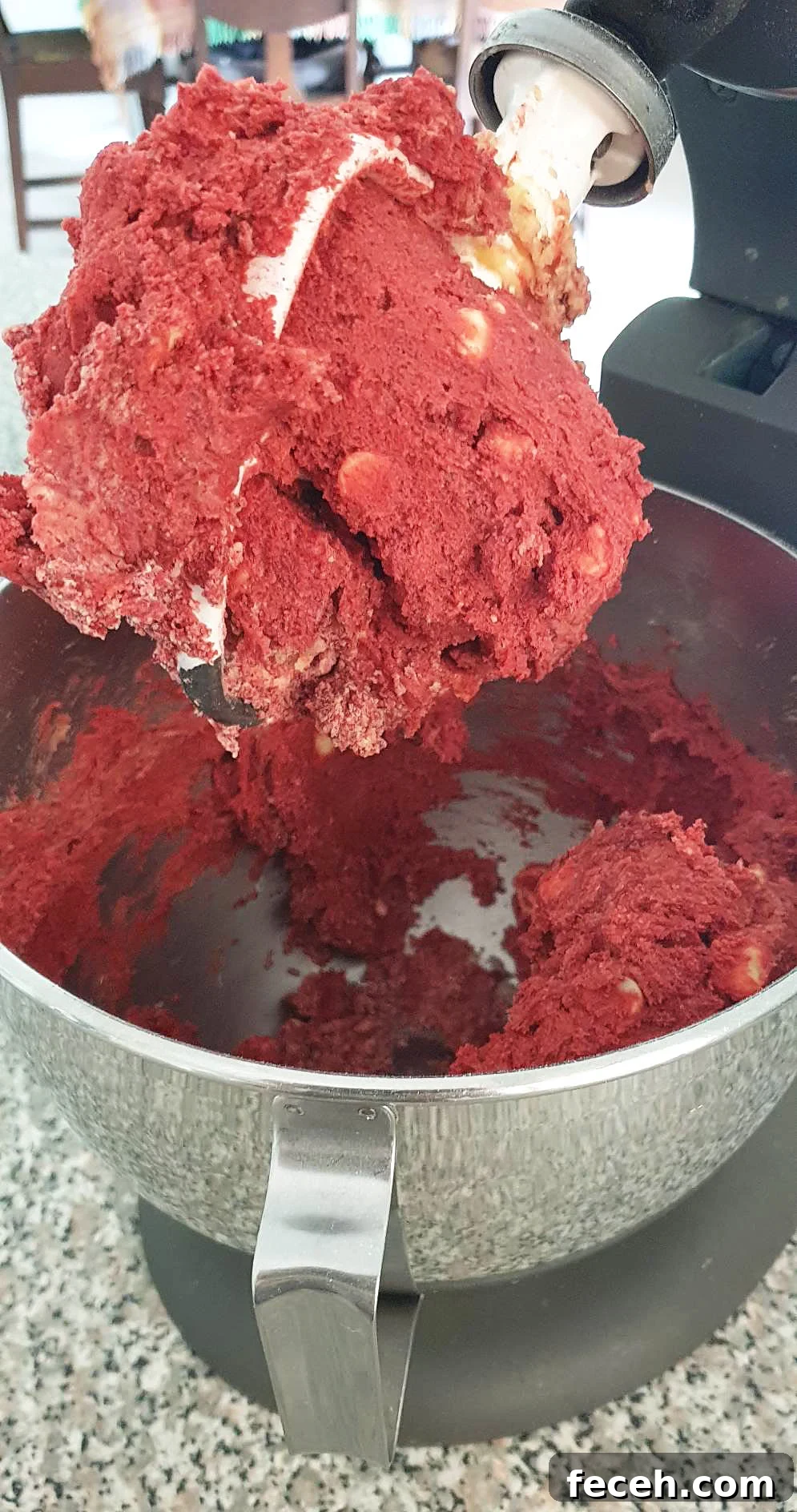 Red velvet cookie dough in a stainless steel bowl.