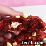 Red velvet cookie split in half.