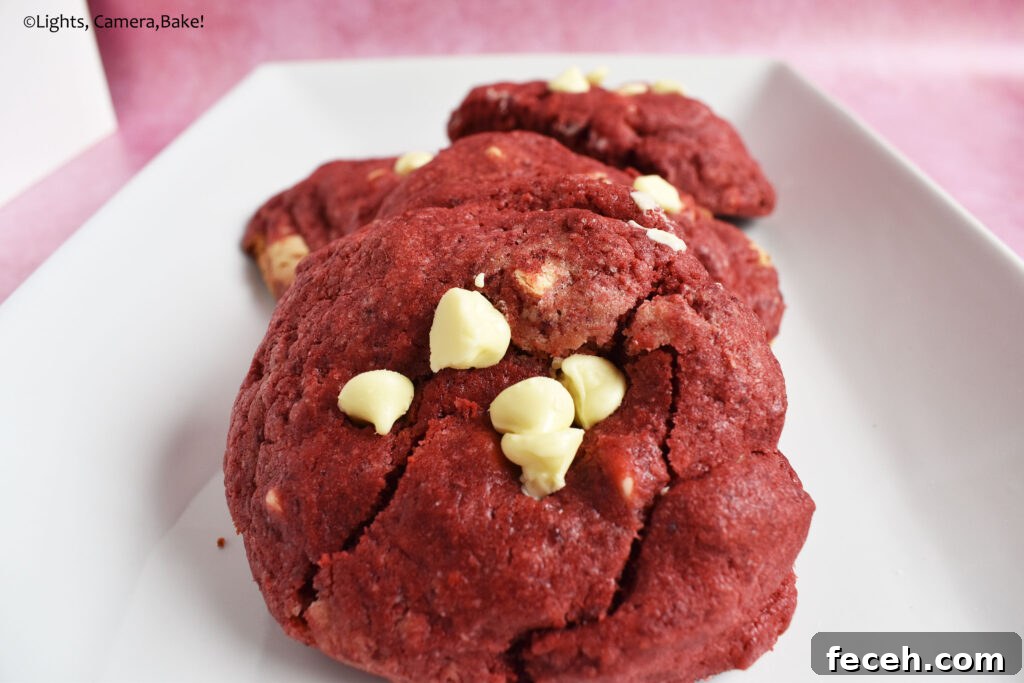 Large bakery red velvet cookies on a plate.