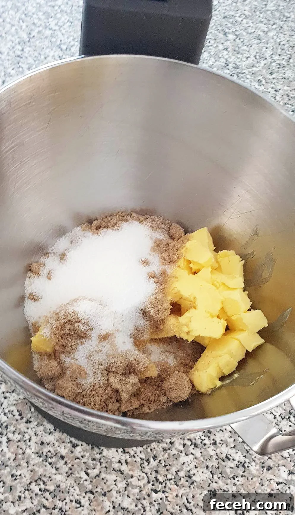 Sugar and butter in a stainless steel bowl.