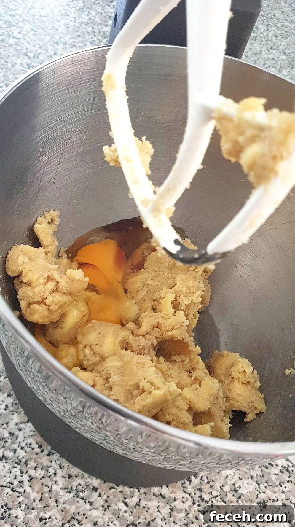 Eggs added into butter mixture for cookie dough.