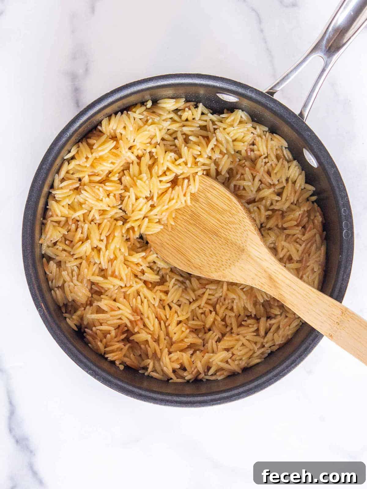 Orzo fully cooked in a medium saucepan.
