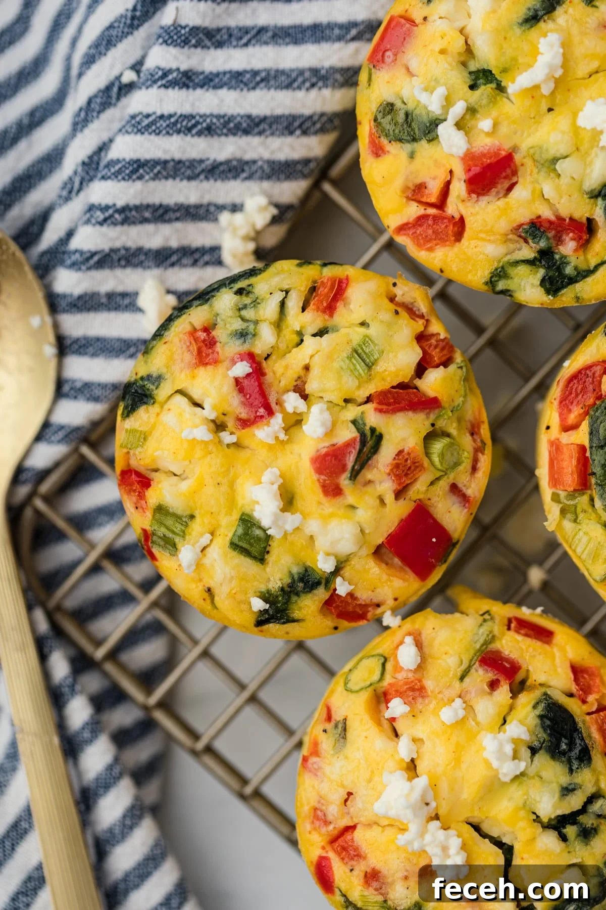 Mini Spinach and Feta Frittatas Recipe 7 A feta and spinach egg muffin cooling on a wire rack.