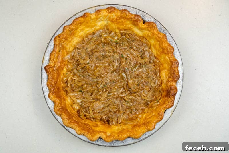 Adding the onions to the pie crust