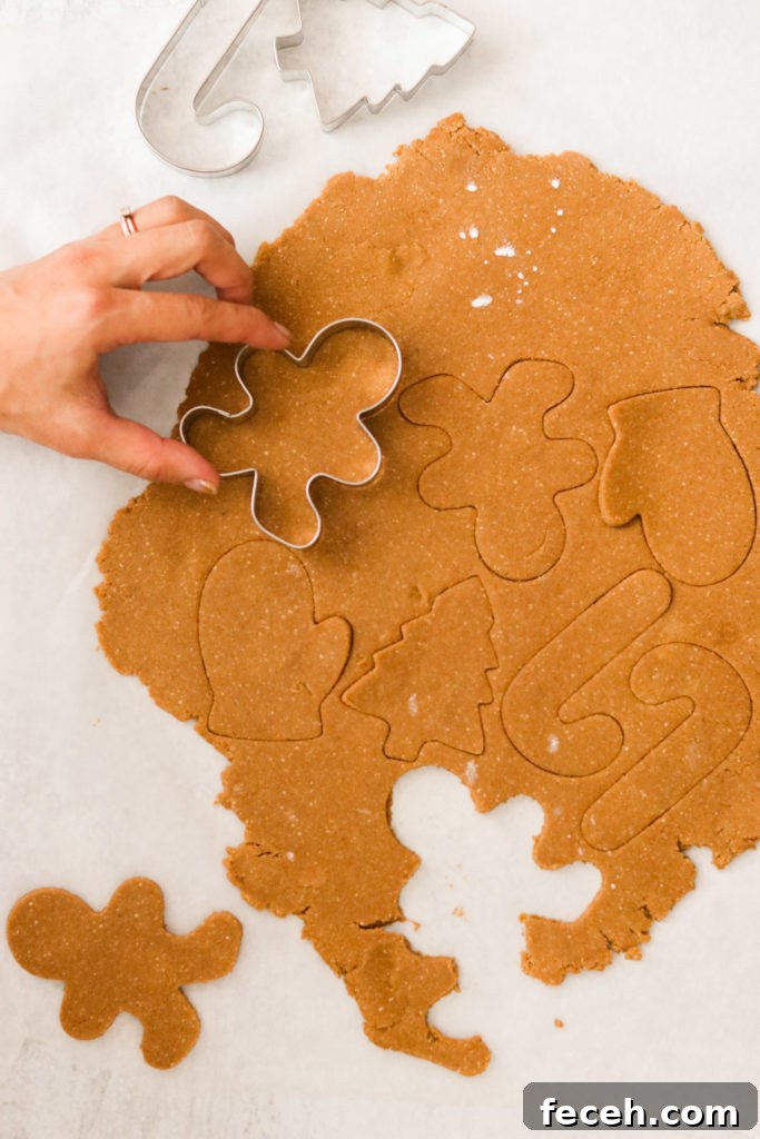 cutting out Paleo gingerbread cookies