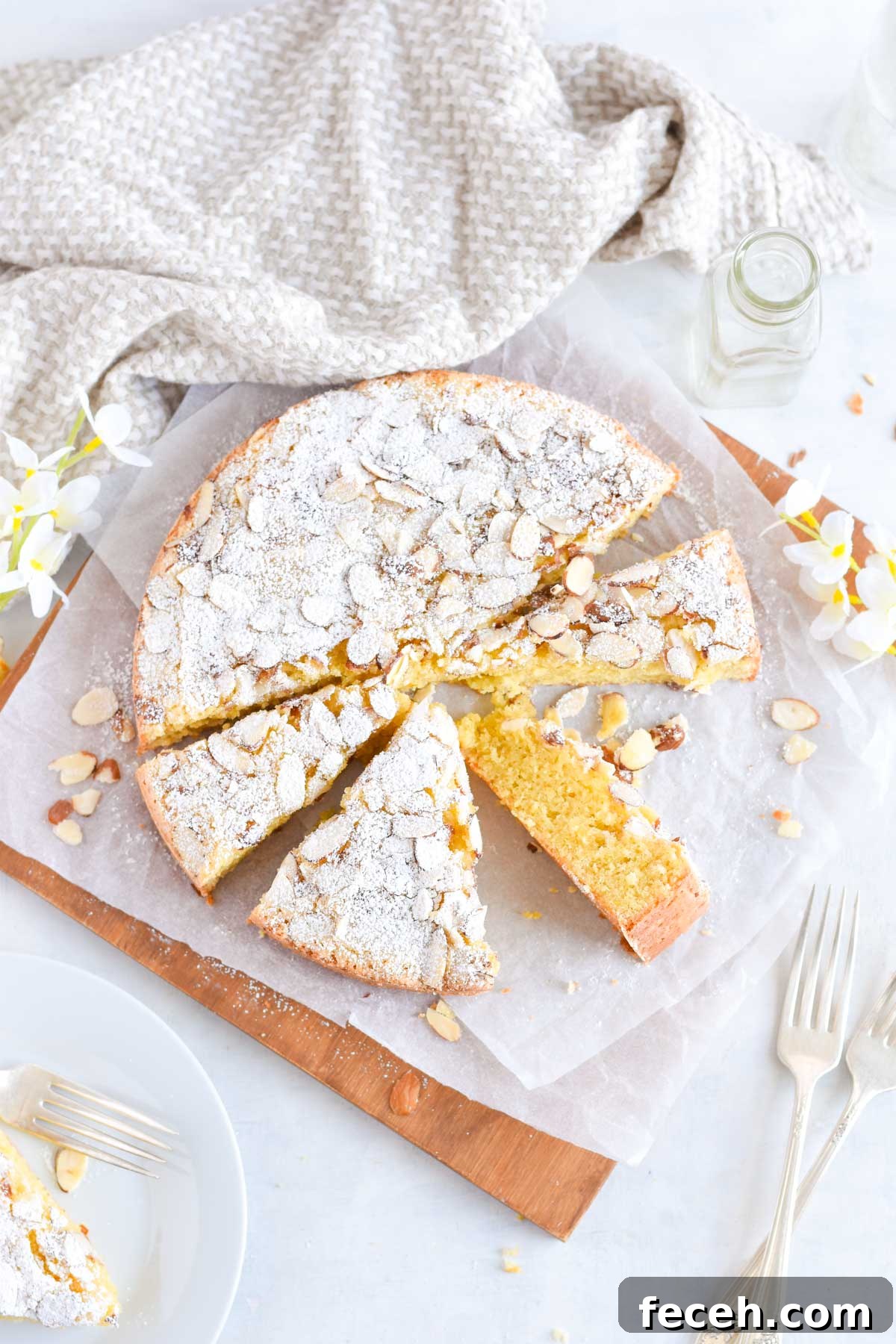 Authentic Italian Almond Cake Recipe — Light & Moist Semifreddo-Free 6 almond cake on wooden board, sliced into triangles.