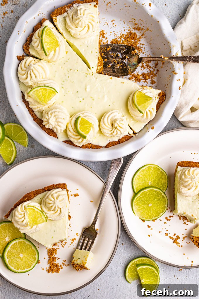 Overhead shot of the best key lime pie. 2 slices of pie are removed from the pie, and on plates. Bites are taken out of the pies. The remaining pie in the pie plate is the background.