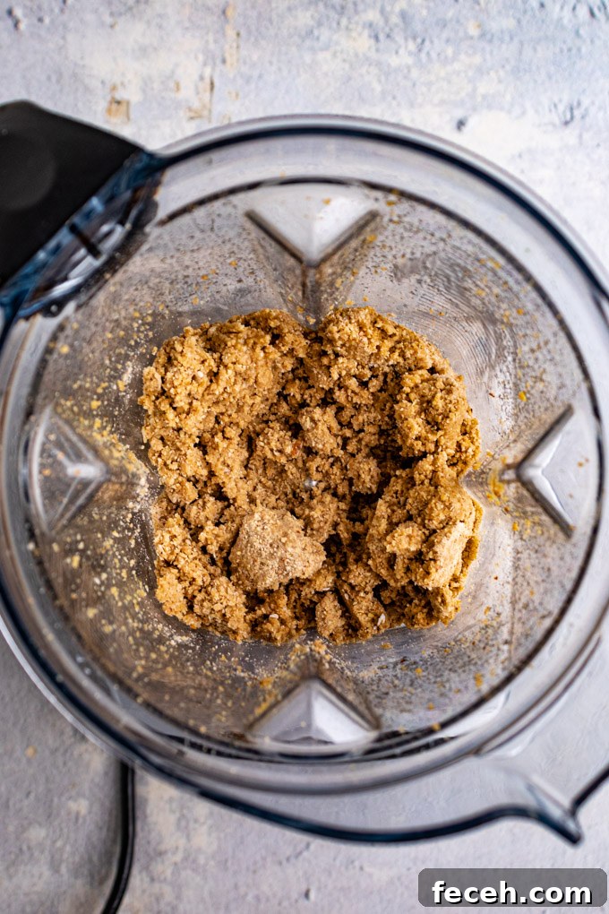 Overhead shot of crust blended in a blender, with butter.