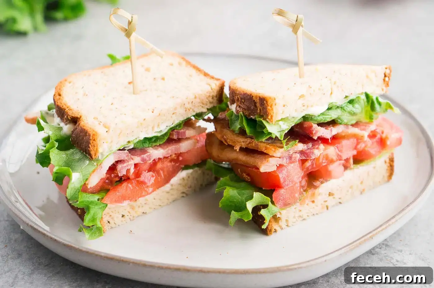 Classic BLT Sandwich Recipe: Crispy Bacon, Lettuce & Tomato 7 bacon lettuce tomato sandwich cut in half