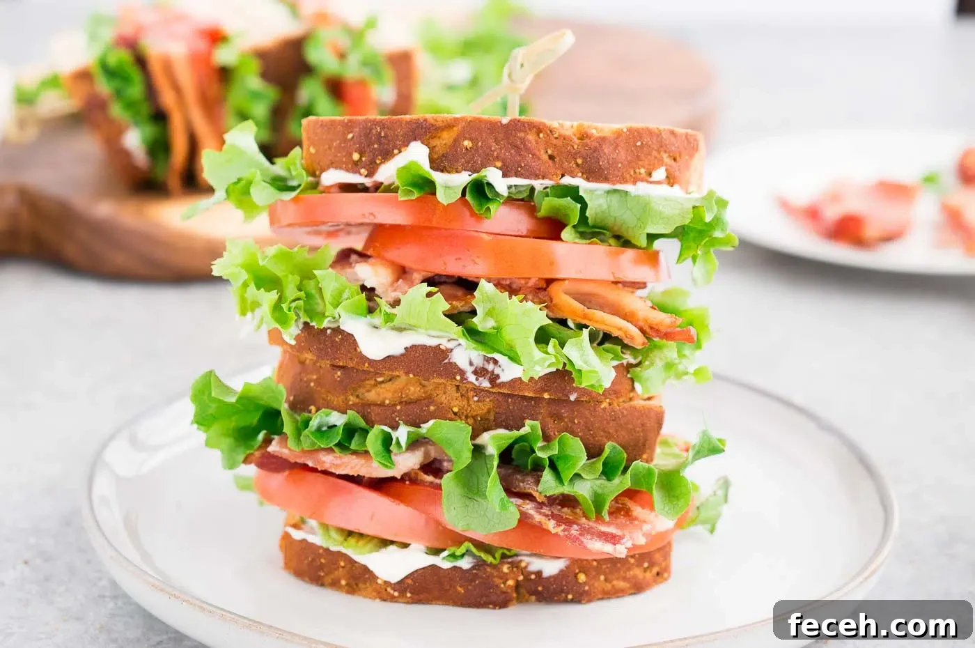 Classic BLT Sandwich Recipe: Crispy Bacon, Lettuce & Tomato 8 stacked homemade BLT sandwich on a plate