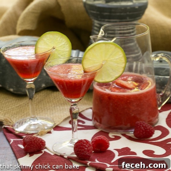 Berry Daiquiris in martini glasses garnished with lime slices